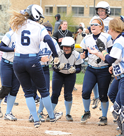 Cassie Young (#6) leaps home on her walk-off grand slam in game one.