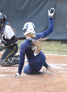 Jamie Young slides into home for the game-winning run in game one at Adrian.