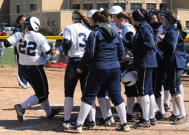 Callie Selner touches home after hitting a walk off two-run home run in game one.