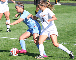 Jenn Jarmy (left) keeps possession of the ball against Calvin. (photo courtesy of Jeff Febus, Calvin SID)