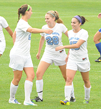 Erin Mishu (right) celebrates her goal with Kathryn Lueking and Kerry Green. Erin Mishu (right) celebrates her goal with Kathryn Lueking and Kerry Green.