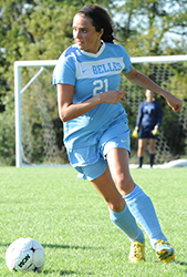 Rachel Moore looks to play the ball upfield. 