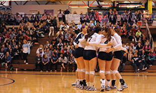 The Belles huddle up at their Domestic Violence Awareness match against Alma.