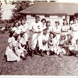 black and white old photo of women's baseball team