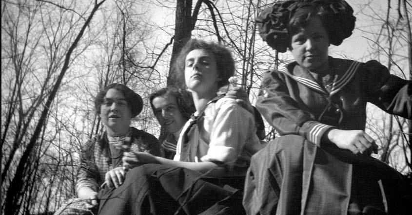 1915 Four students along the bank of the St. Joseph River