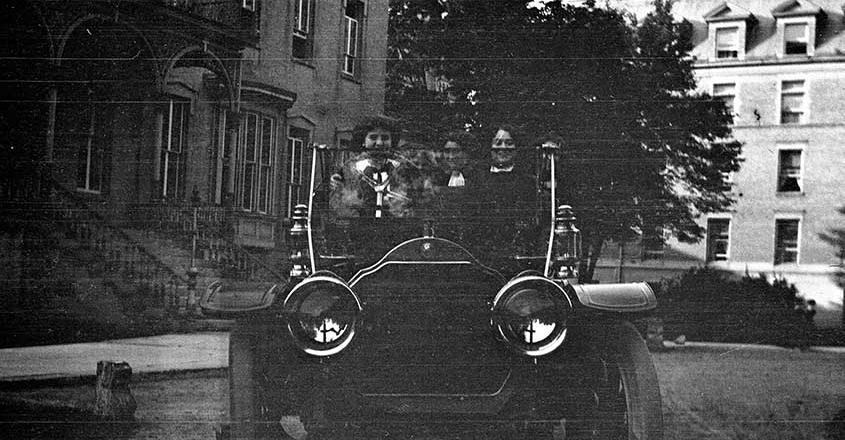 1915 students in car in front of building