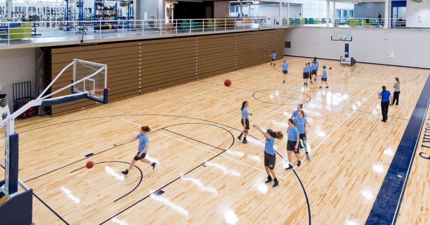 Students playing basketball at Angela Athletic & Wellness Complex